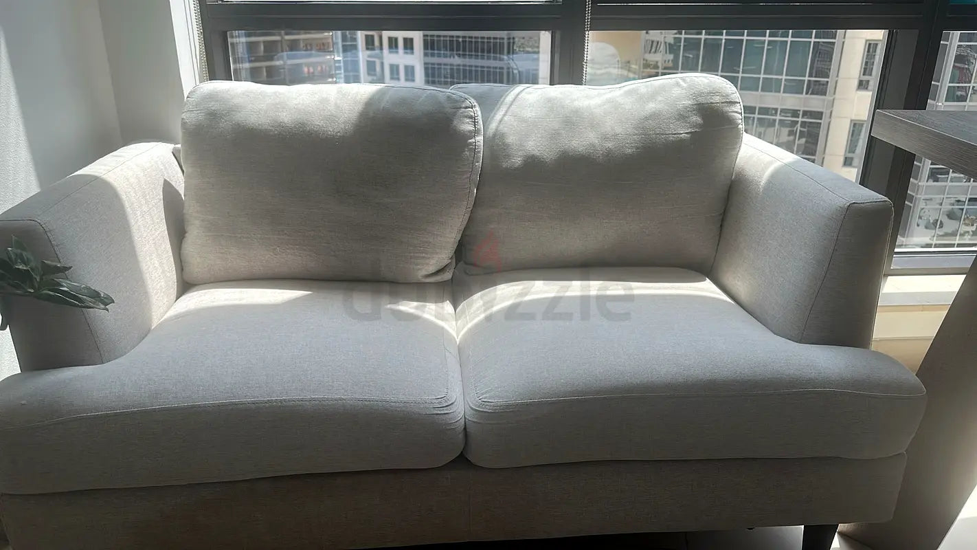 Pre-loved 2-seater light grey fabric sofa