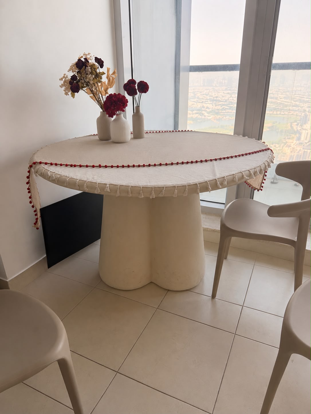 Cream round dining table with sculptural base
