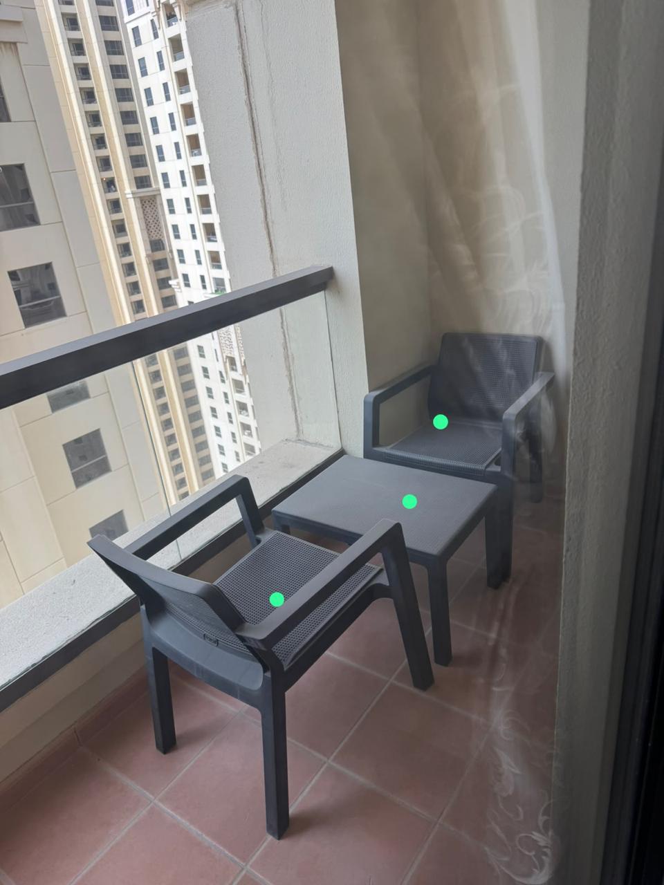 Dark grey balcony set with 2 armchairs and square coffee table on apartment balcony