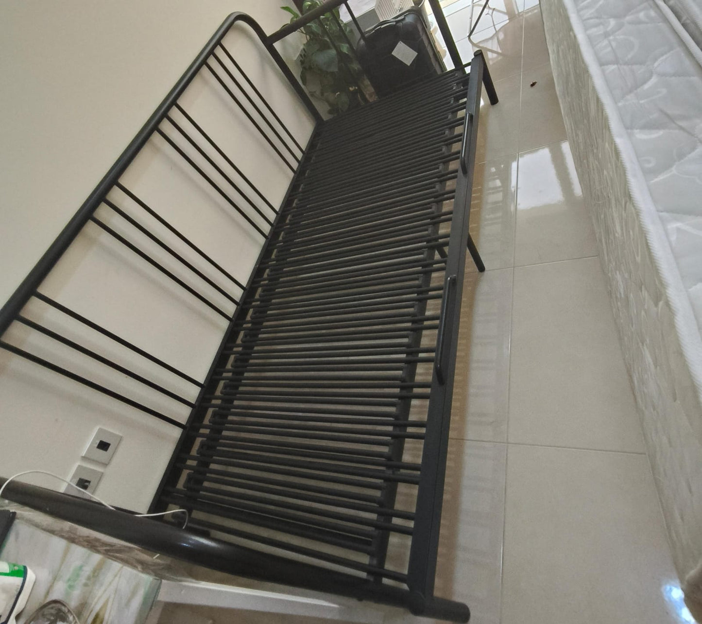 Black metal single bed frame with slatted base