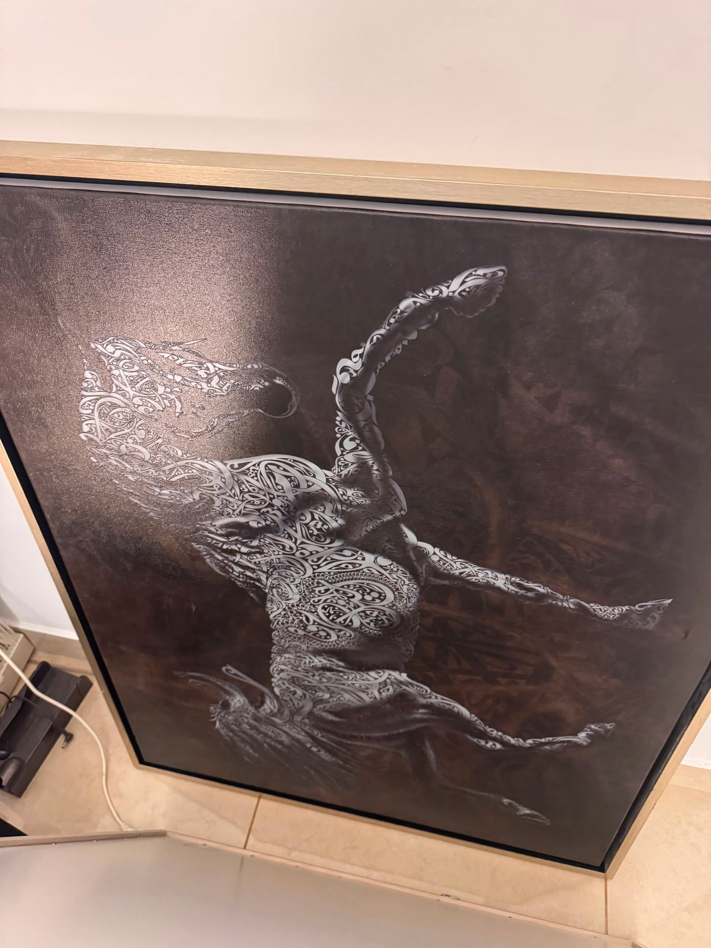 Framed canvas wall art of a dancer made from tribal calligraphy patterns