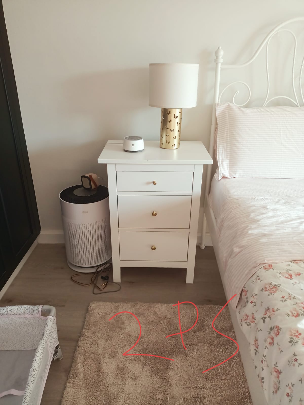 Original photo of white three-drawer bedside table beside bed