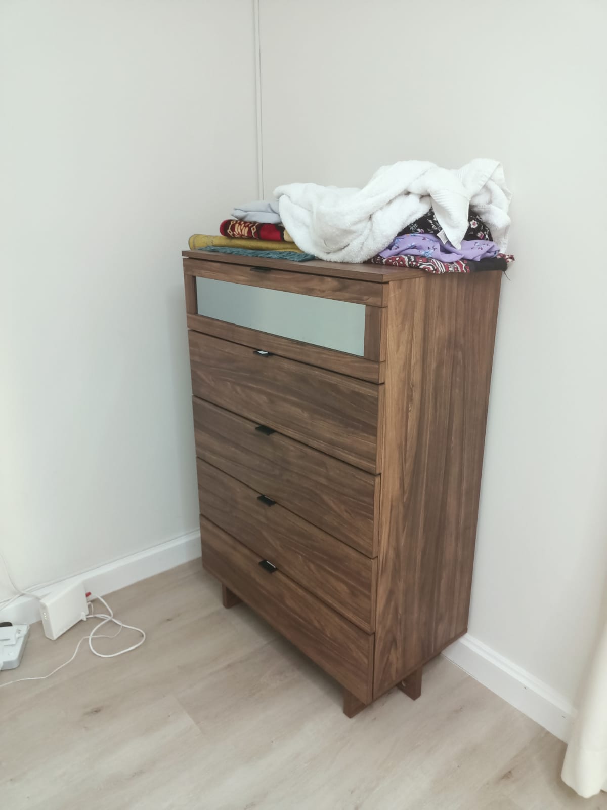 Tall wood-look chest with frosted-look upper panel and lower drawers