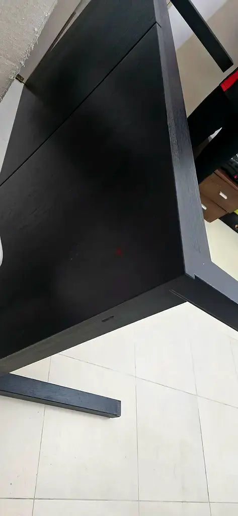Black wooden desk with sled base