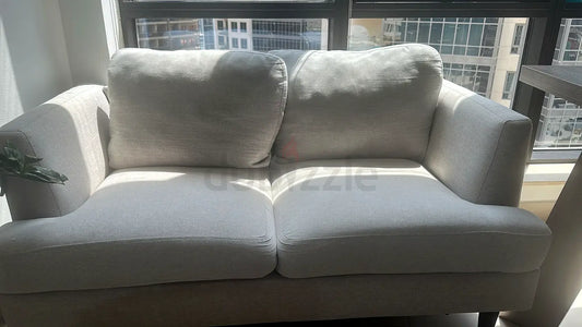 Pre-loved 2-seater light grey fabric sofa