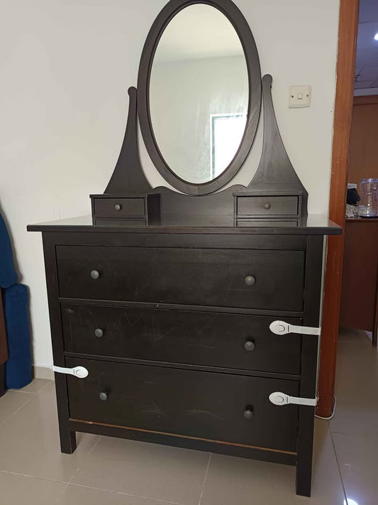 Dark wood dresser with oval mirror and three drawers