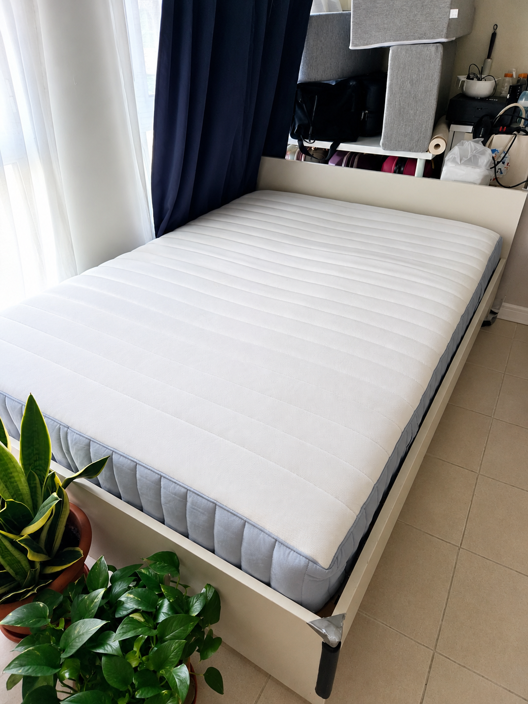 White bed frame with mattress - angle view