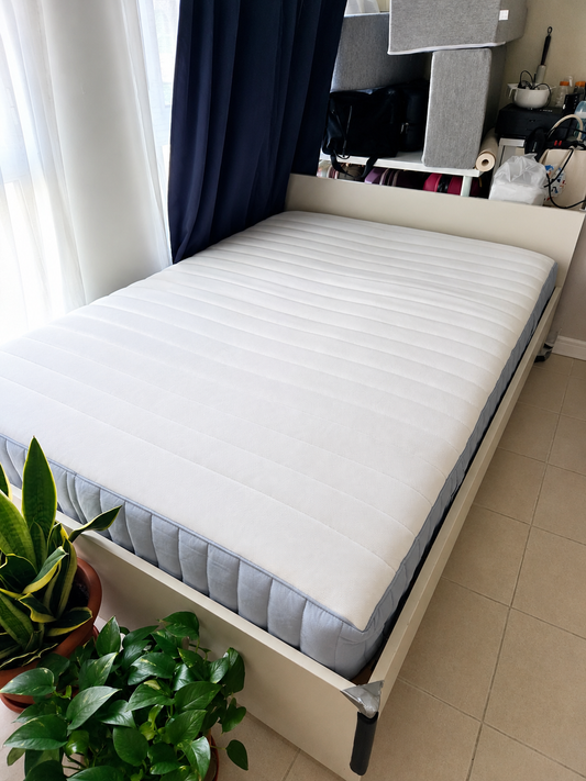 White bed frame with mattress - angle view