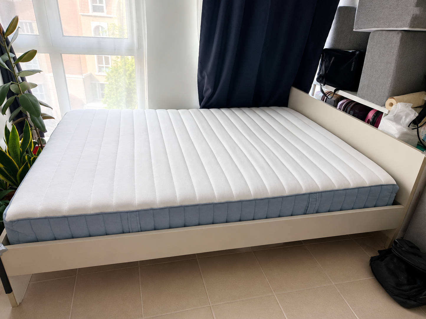 White bed frame with mattress - side view