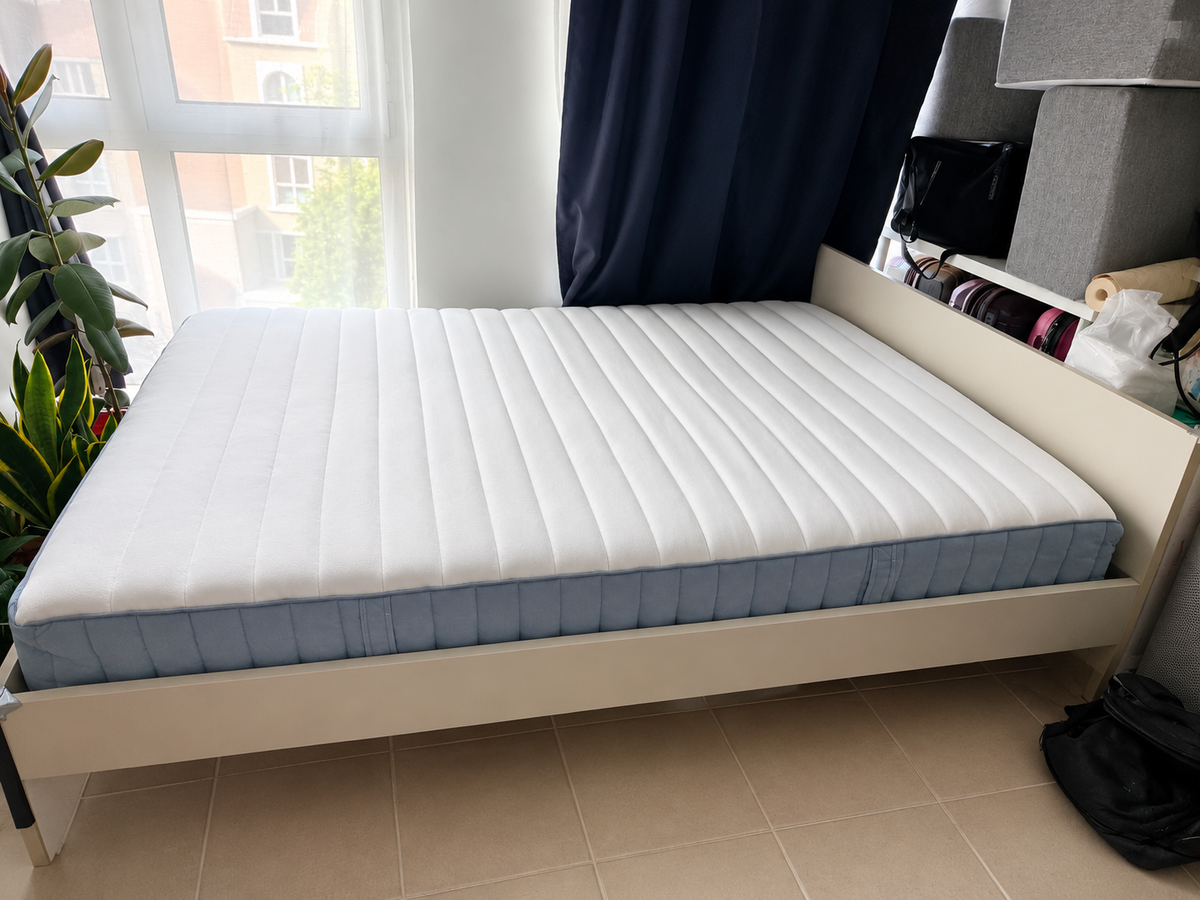White bed frame with mattress - side view