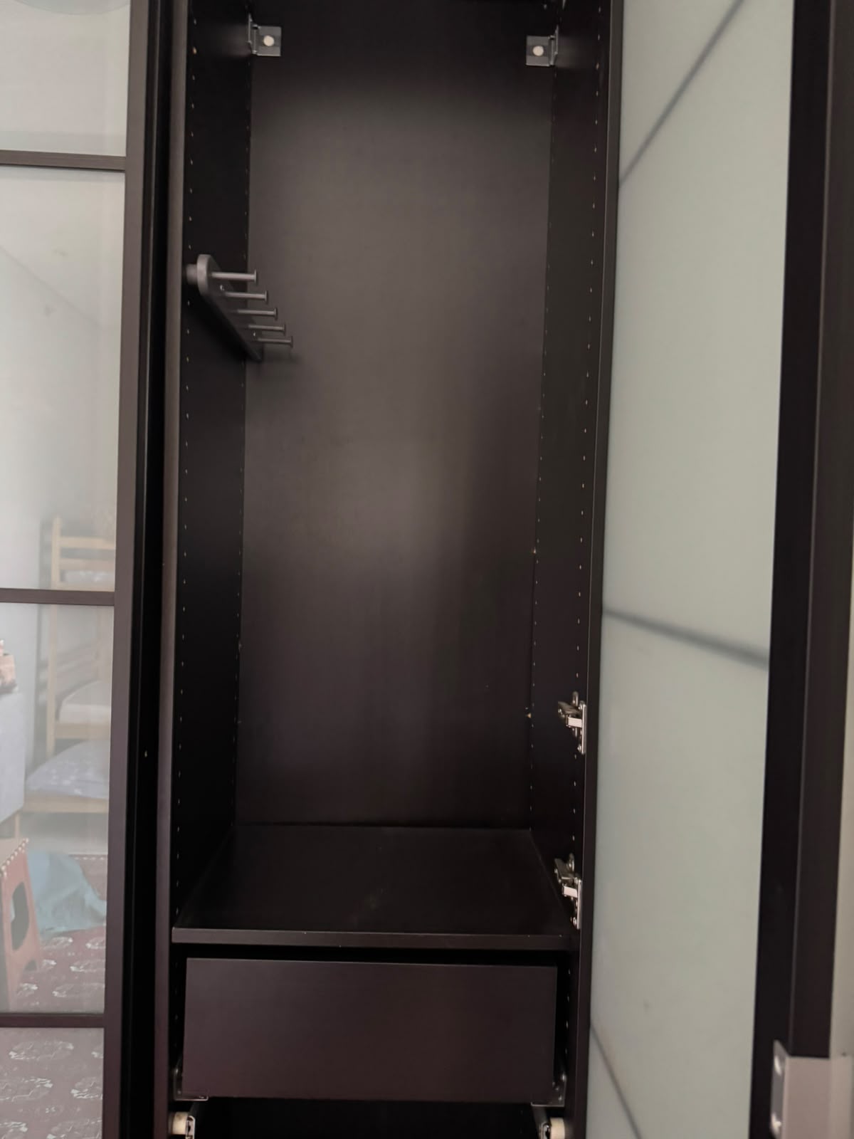 Wardrobe interior showing hanging section and bottom drawer