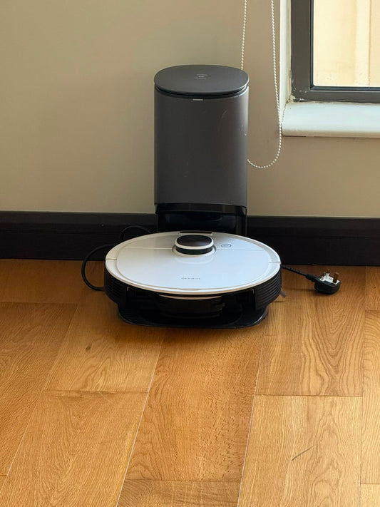 Ecovacs Deebot robot vacuum on charging dock with auto-empty station