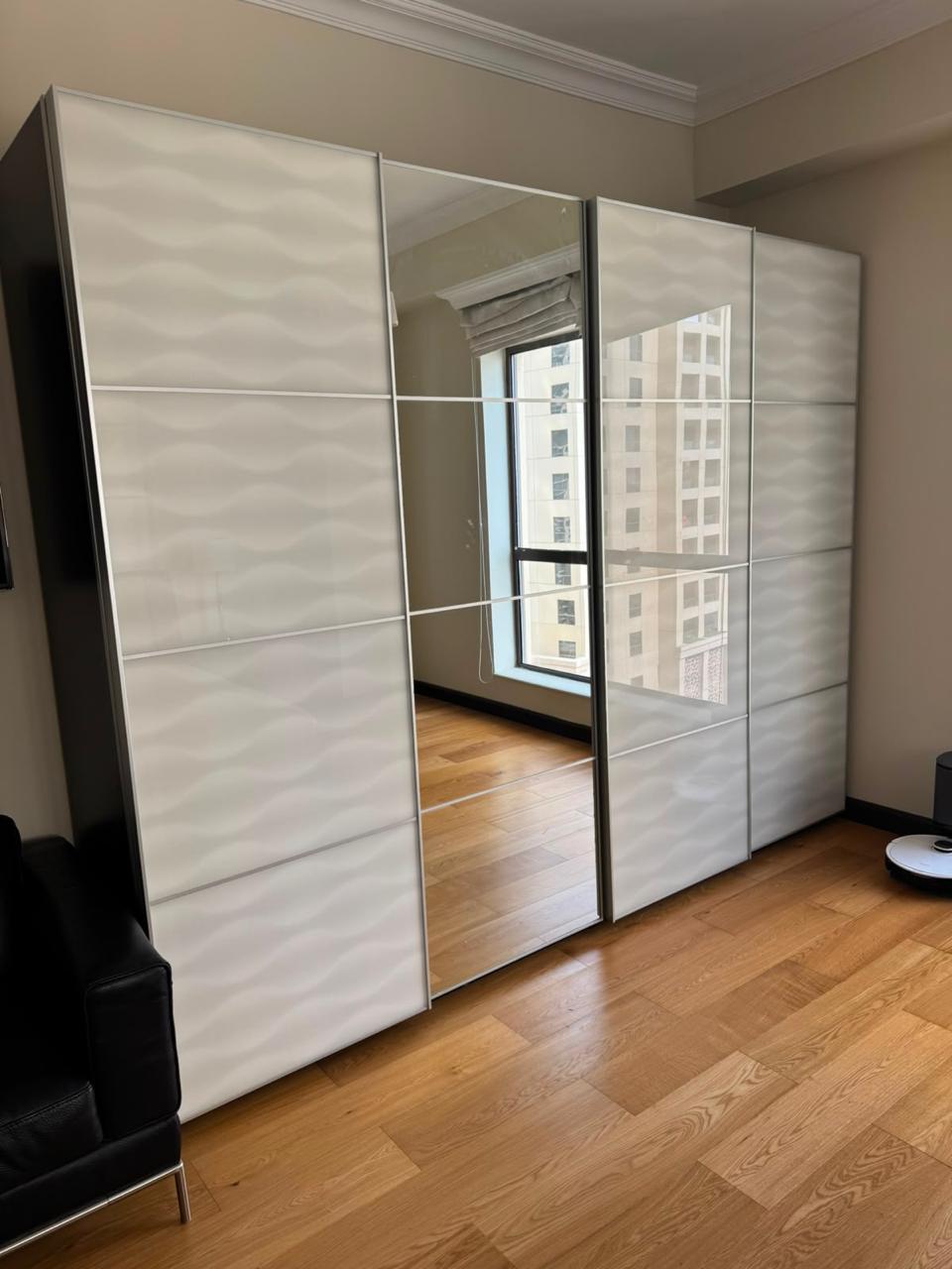 Large white sliding door wardrobe with mirror panel, full exterior view