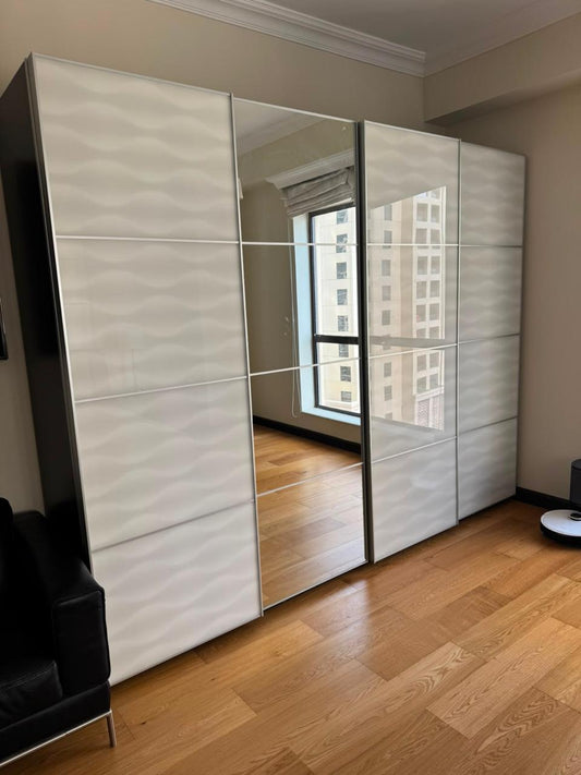 Large white sliding door wardrobe with mirror panel, full exterior view
