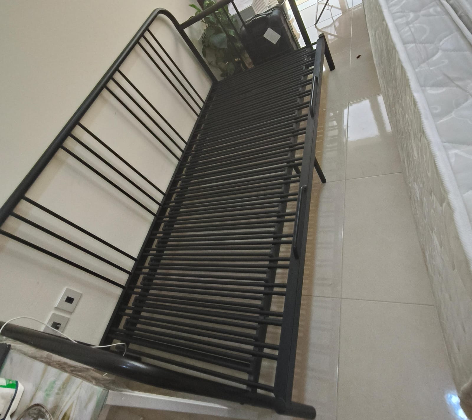 Black metal single bed frame with slatted base