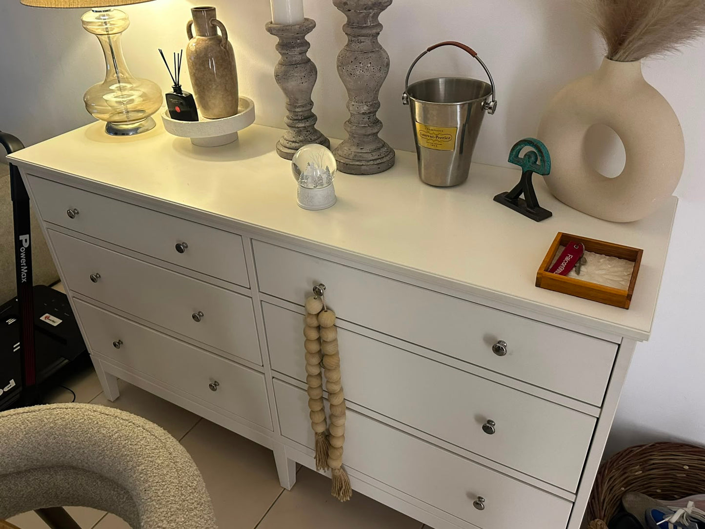 White 6-drawer dresser with silver knob hardware styled with home decor