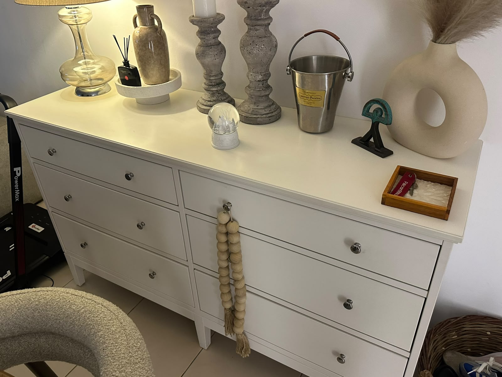 White 6-drawer dresser with silver knob hardware styled with home decor