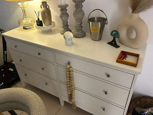 White 6-drawer dresser with silver knob hardware styled with home decor
