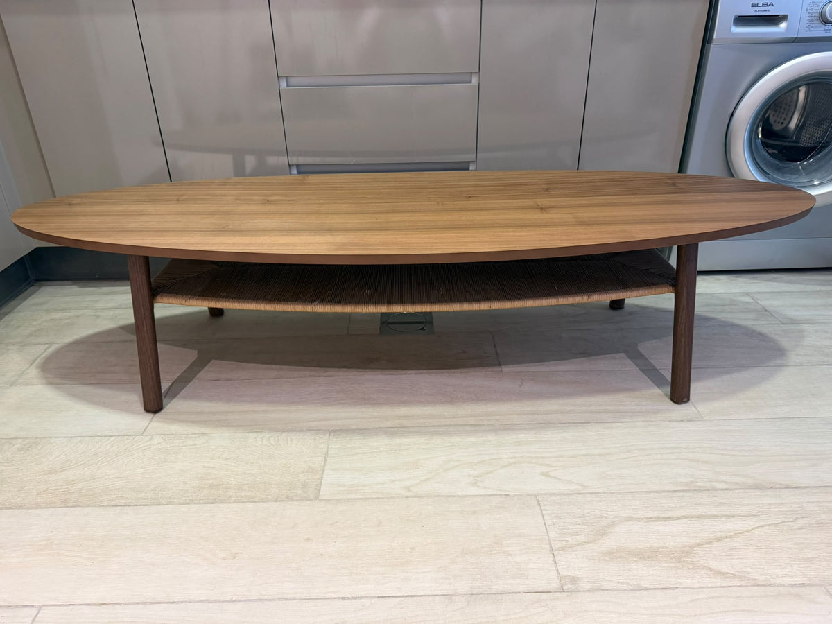 Oval wood-finish coffee table with rounded edges and an open lower shelf