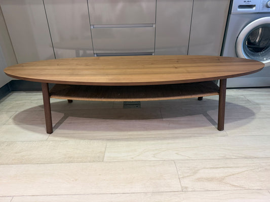 Oval wood-finish coffee table with rounded edges and an open lower shelf