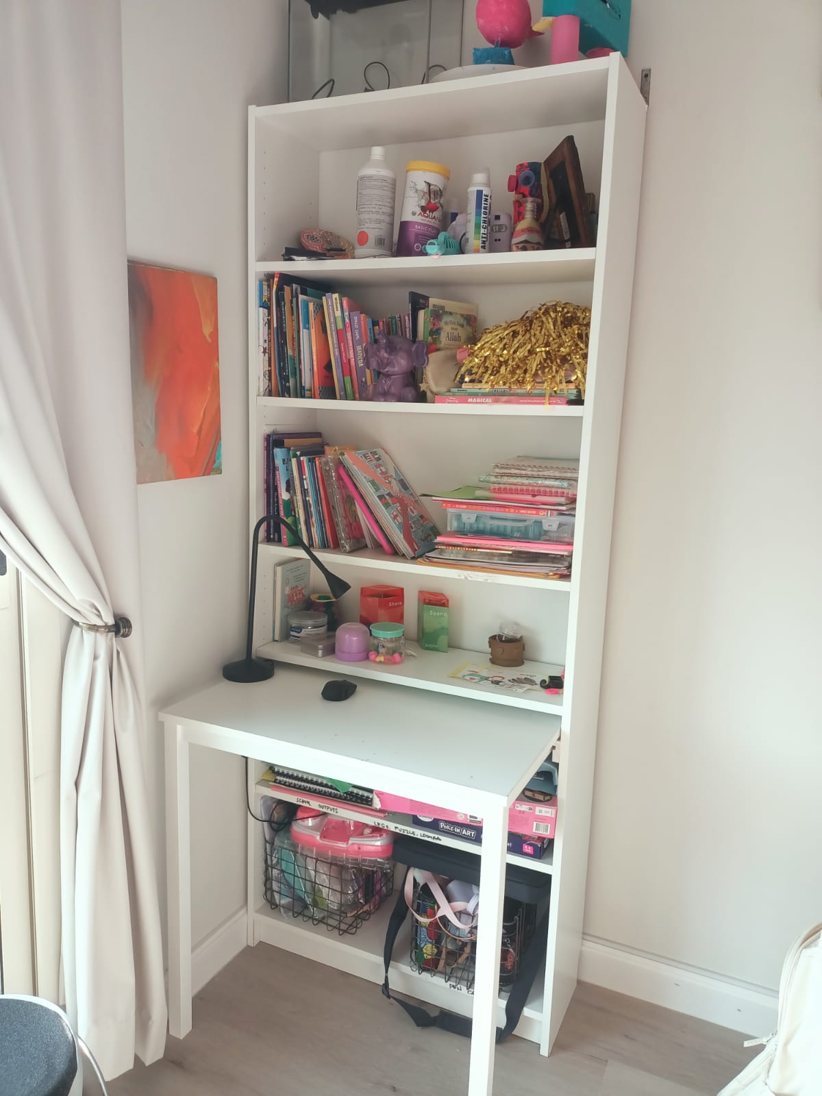Original photo of white desk in front of tall open bookcase