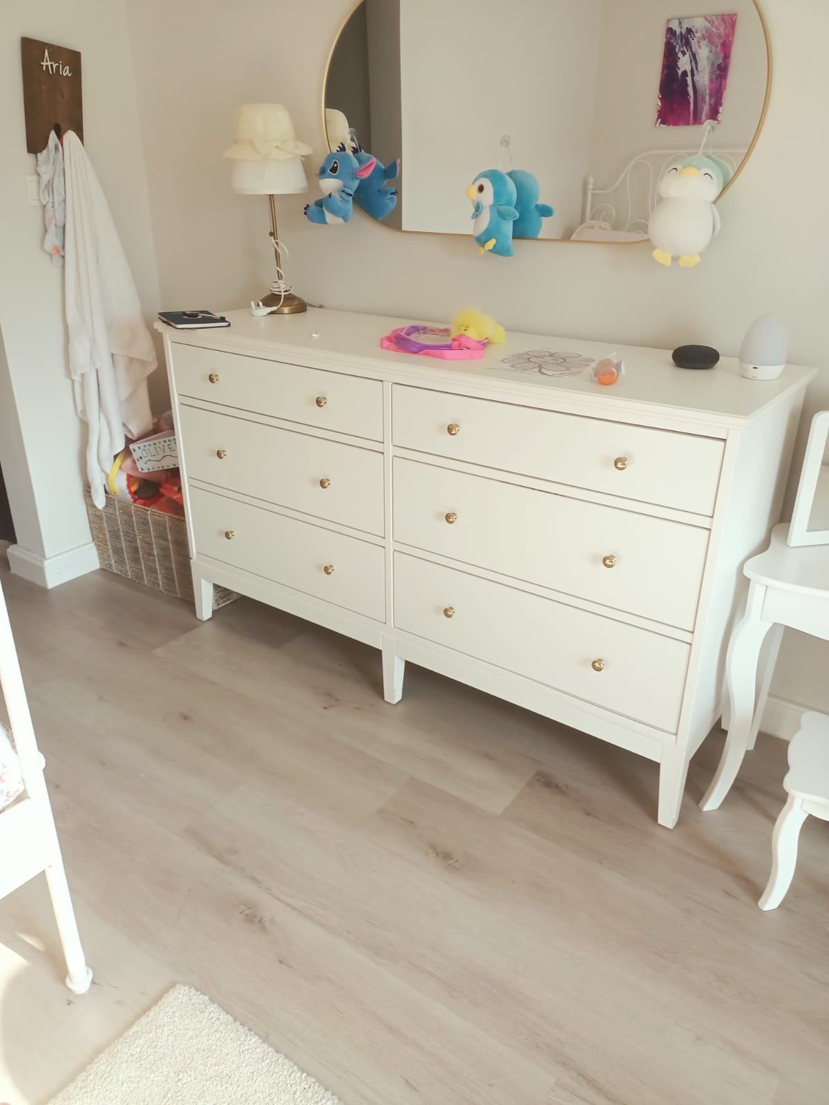 Original photo of wide white six-drawer dresser beneath wall mirror