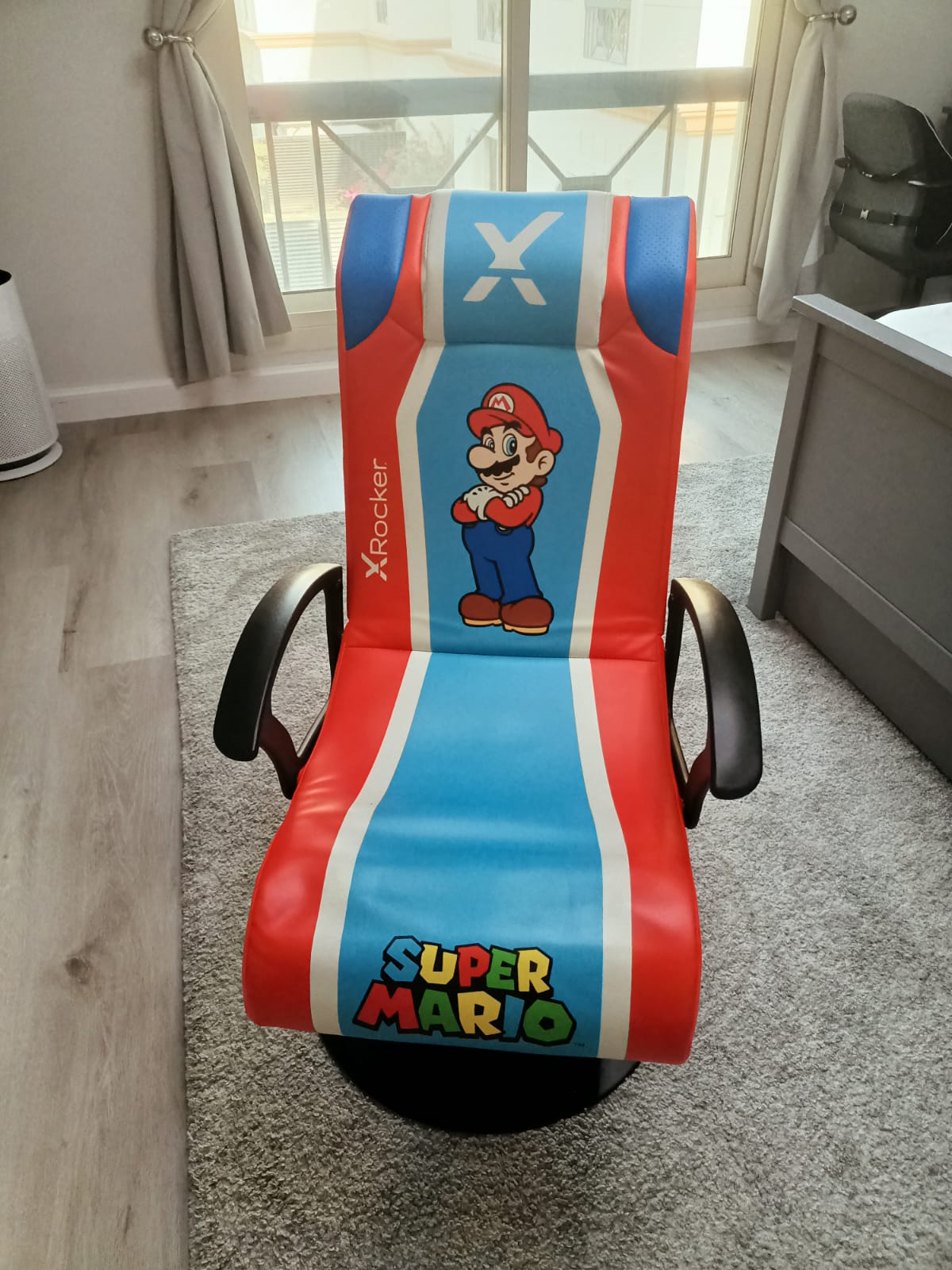 Red and blue X Rocker Super Mario floor gaming chair with black armrests