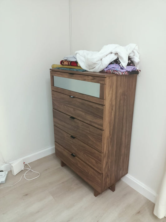 Tall wood-look chest with frosted-look upper panel and lower drawers