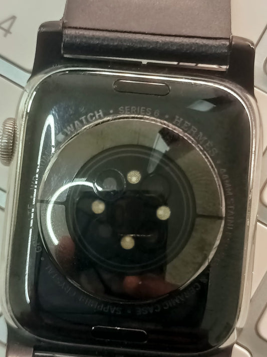 Original close-up of the back of a used Apple Watch Series 4 with dark strap