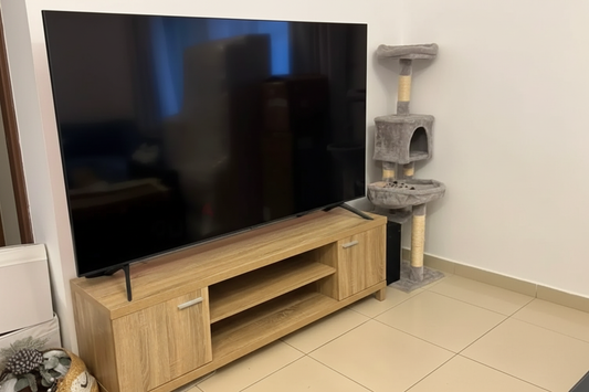 Oak TV stand with large flat screen TV, bright lighting