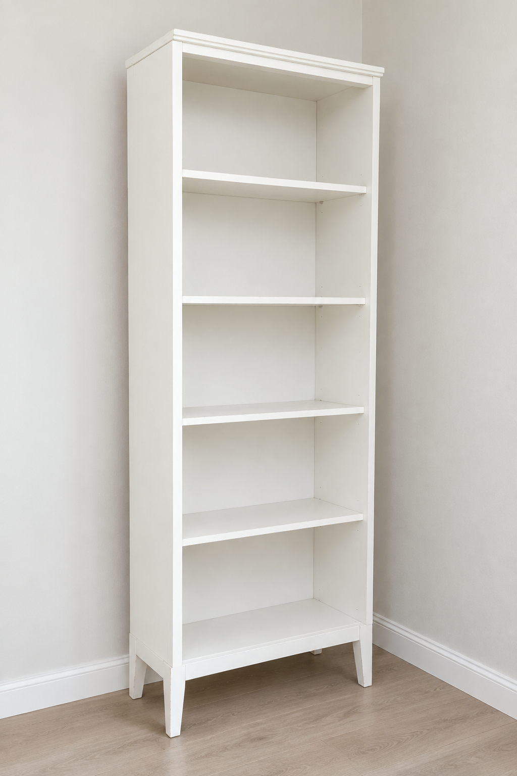 Edited photo of tall white open bookcase with five shelf levels