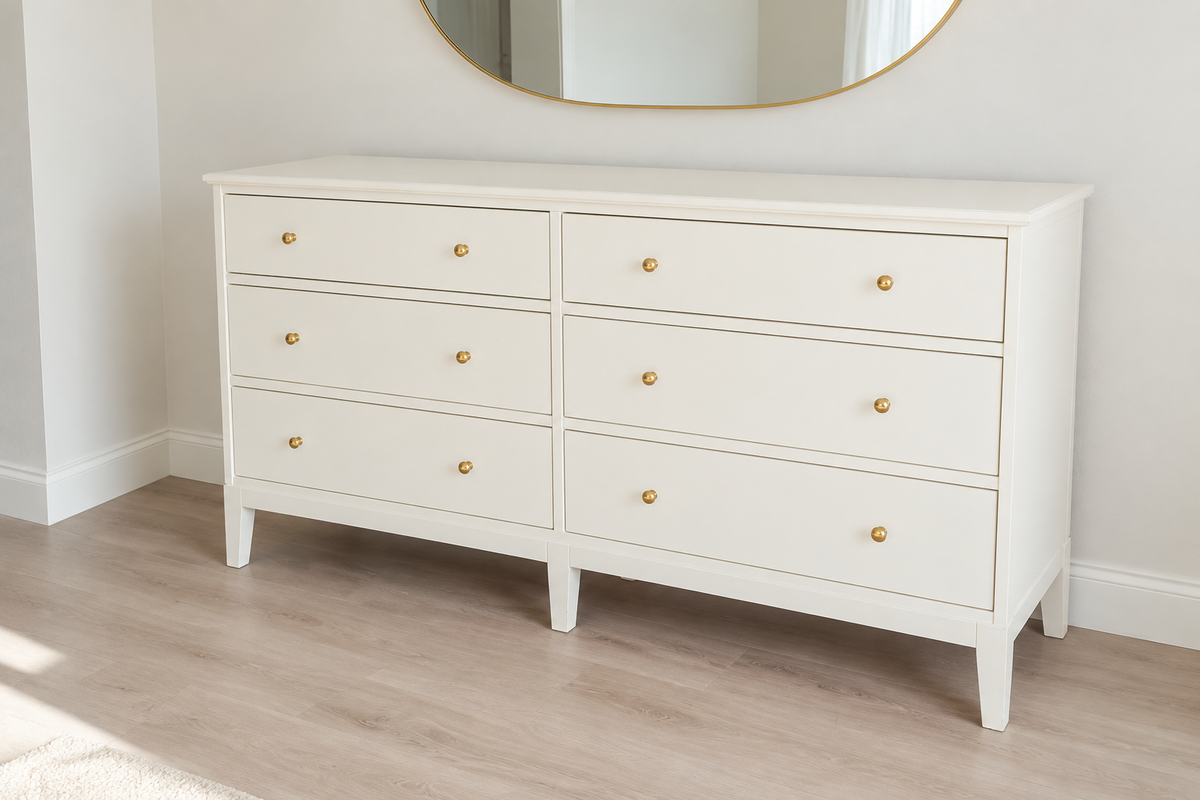 Edited photo of wide white dresser with six drawers and gold-tone knobs