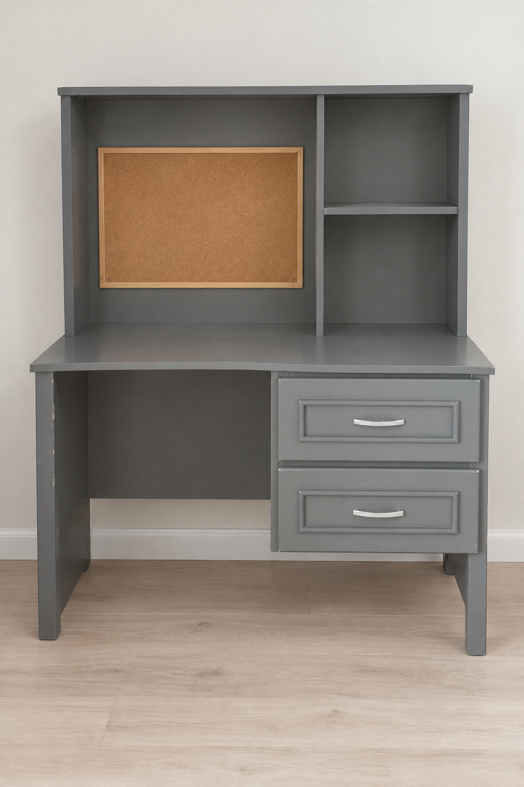 Edited photo of grey study desk with corkboard hutch, shelves and two drawers