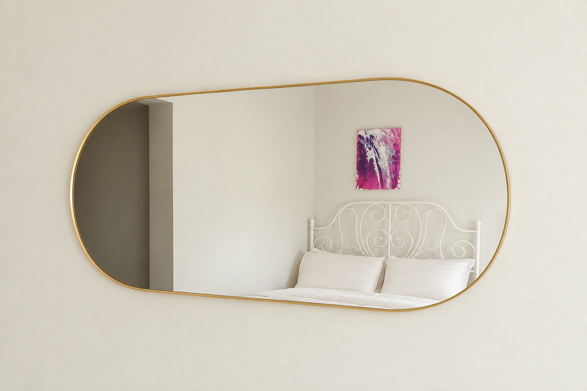 Edited photo of wide irregular rounded wall mirror with thin gold-tone rim
